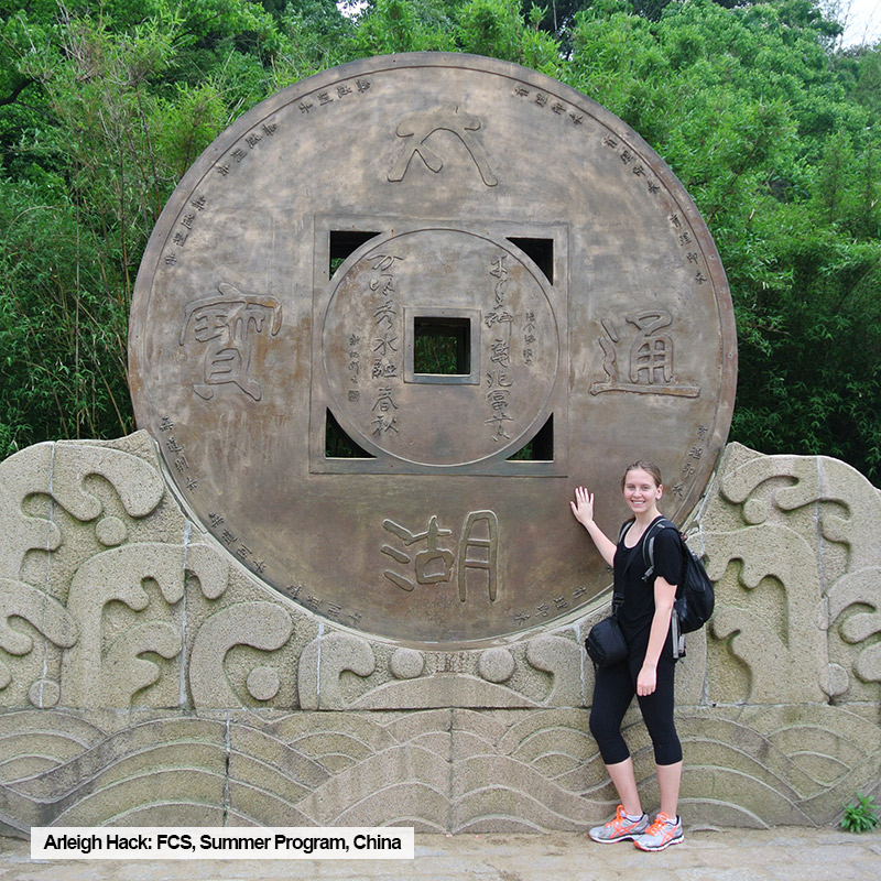 Toronto Metropolitan University FCS student, Arleigh Hack, poses with monument during summer program in China.