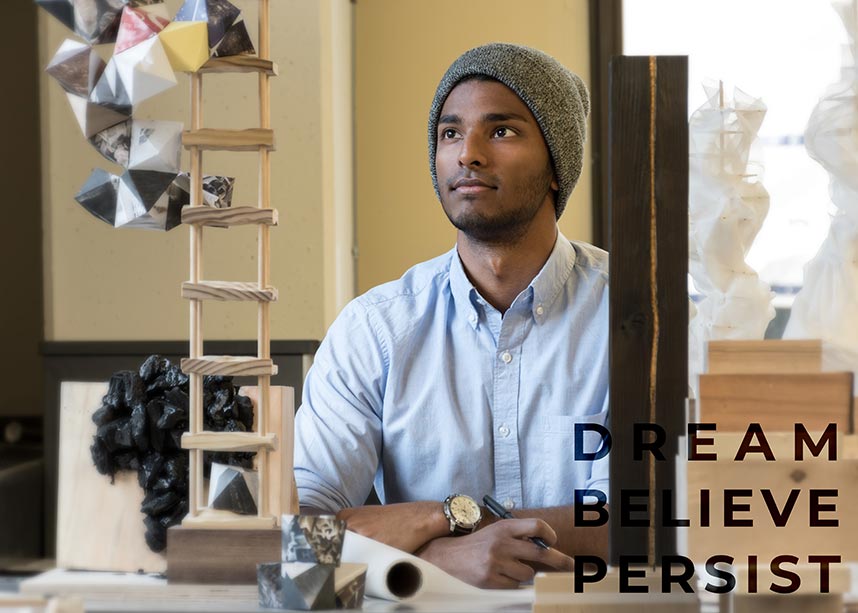 Ryan Fernandes sitting in architecture lab: "Dream, Believe, Persist"