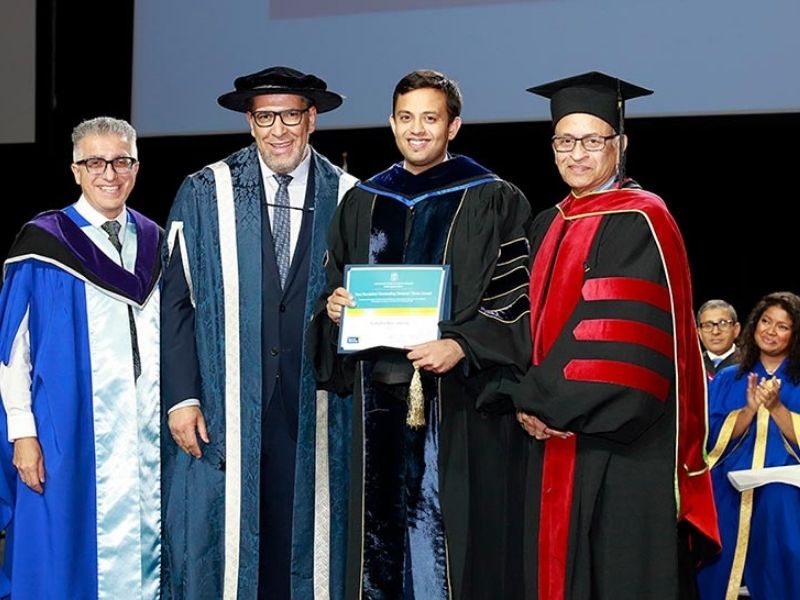 Dr. Yashodhan Rajiv Athavale accepts the C. Ravi Ravindran Outstanding Doctoral Thesis Award at the 2019 convocation ceremony