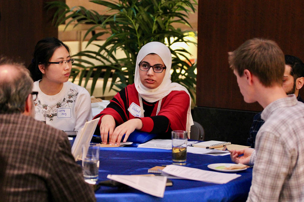 Grad student participant talking to group facilitator