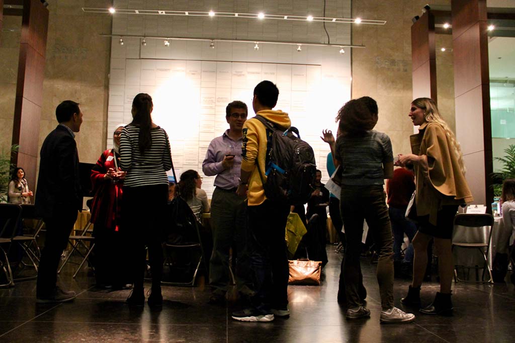 Grad students talking in Sears Atrium