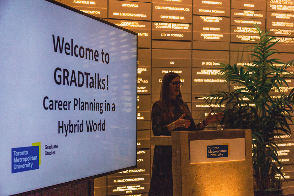 Dr. Nancy Walton presenting at GRADTalks on stage in Sears Atrium