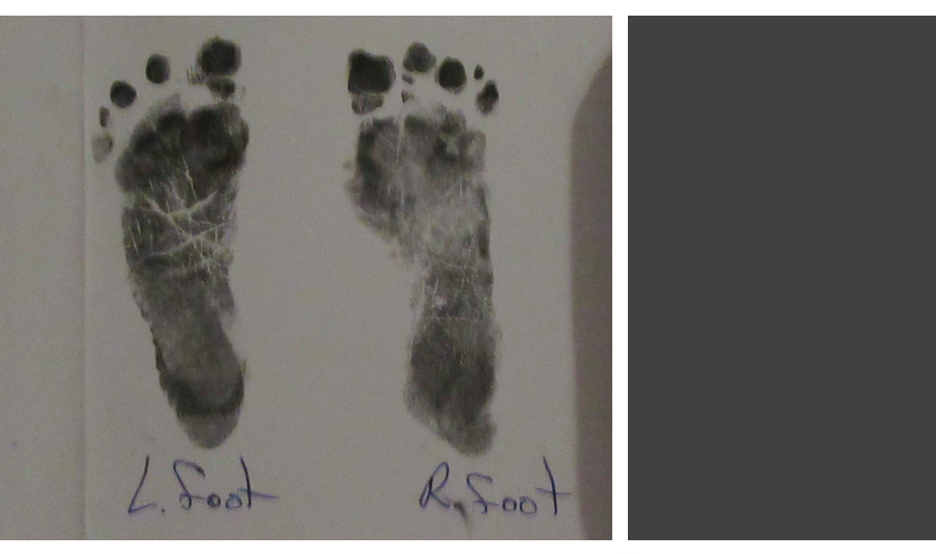 Two ink footprints from a newborn baby. Left foot. Right foot. 