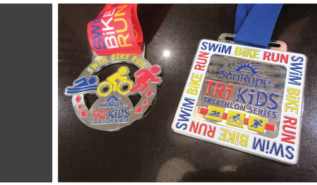 Two triathlon participation medals