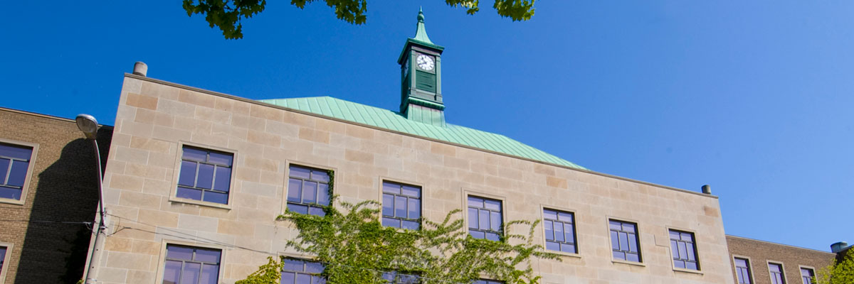 Kerr Hall south with the clock tower on a bright blue background.