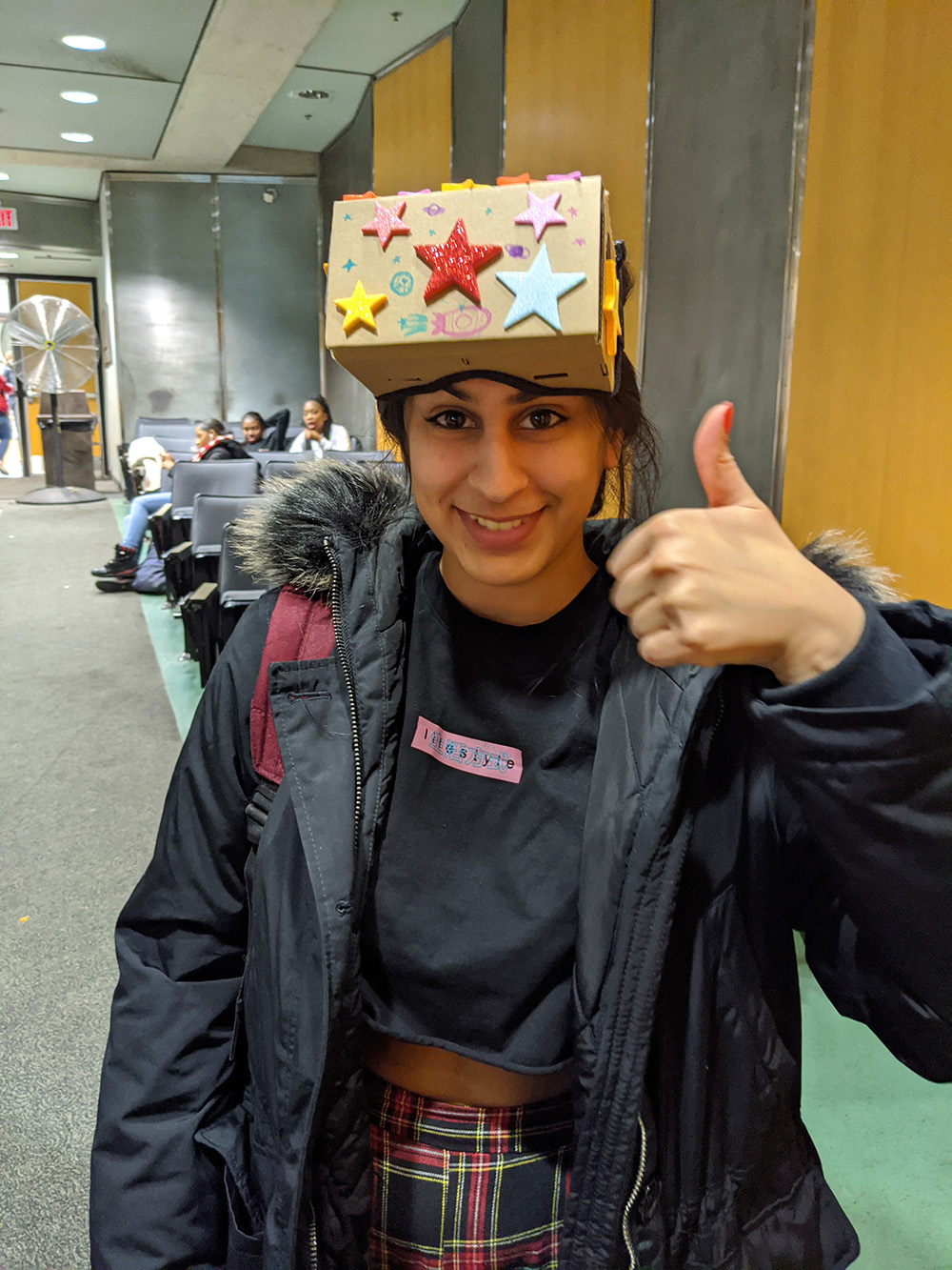 A student with a cardboard VR made as part of the T. project.