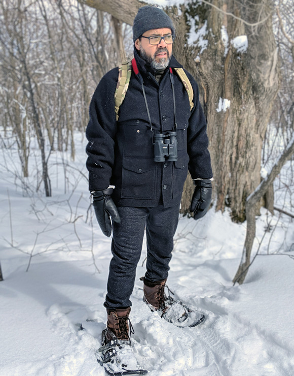Marcus Santos snow-shoeing in the woods.