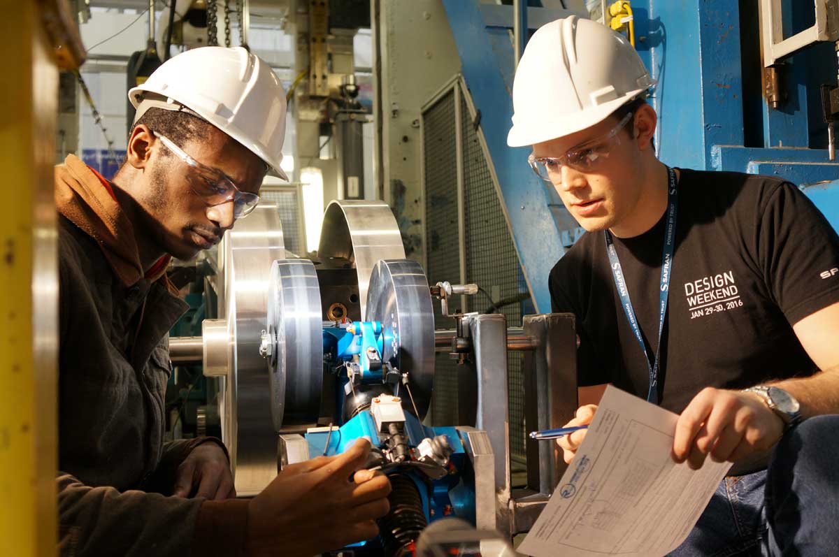 Two male students working on wheel-deployment technology