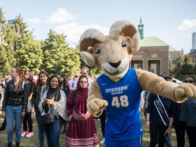 Eggy the Ram in the quad with students