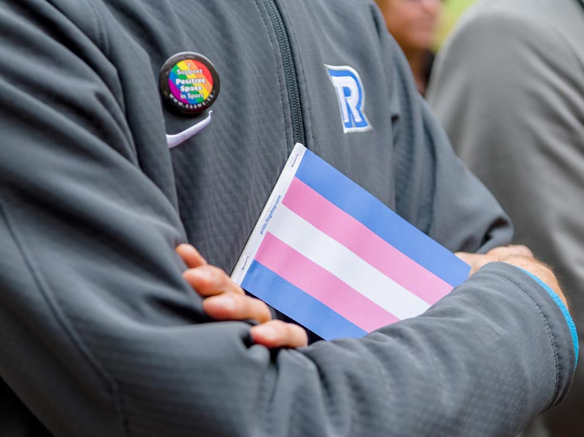 A Ryerson community member holding a Transgender Pride flag
