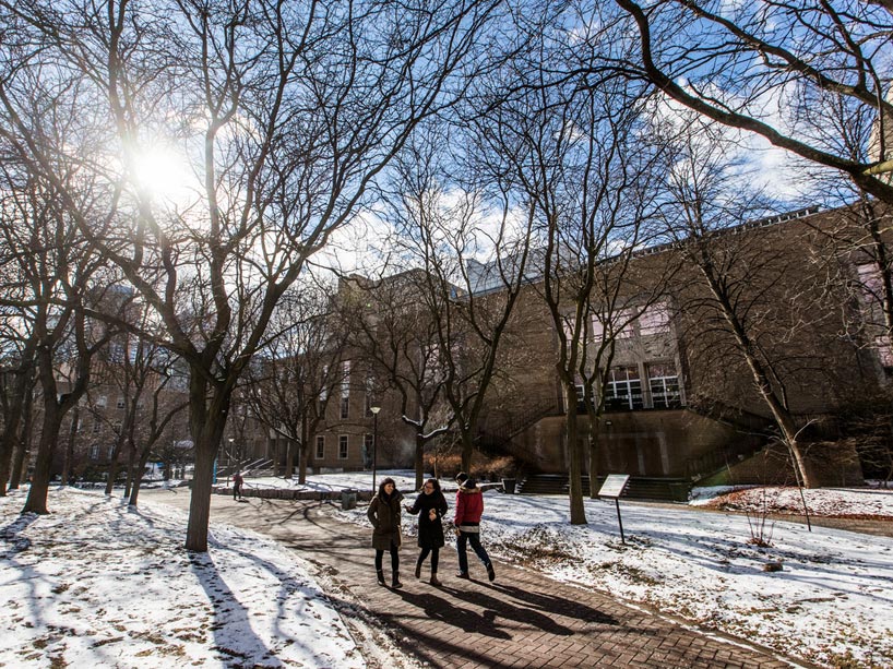 Two women walking through the quad in winter
