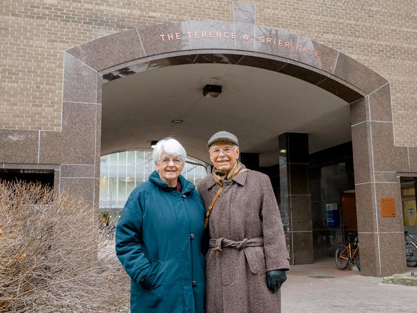 Terry Grier, right, and his wife standing in front of the quad archway
