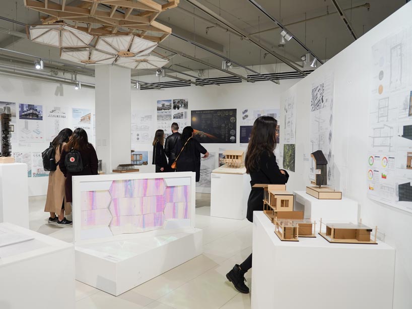 Various people in a room looking at architectural models and drawings
