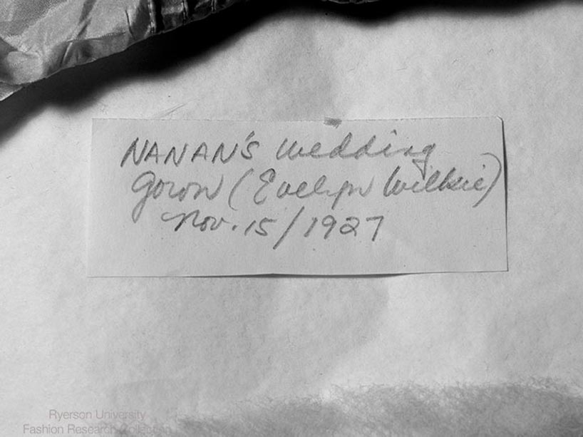 Black and white photo of a label that reads Nanan’s wedding gown (Evelyn Wilkie) Nov. 15/1927