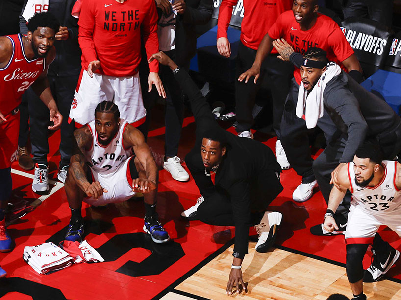 Close up of Kawhi Leonard and his teammates watch the game-winning basket go in