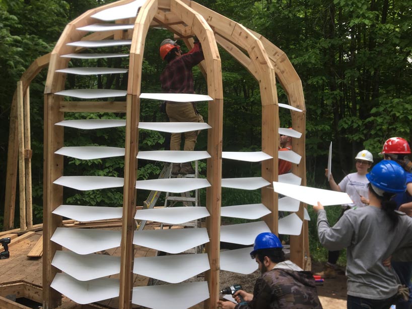 Students placing gatorboard fins in the structure