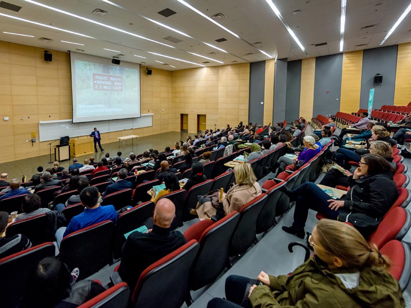 A professor teaching a lecture hall full of students