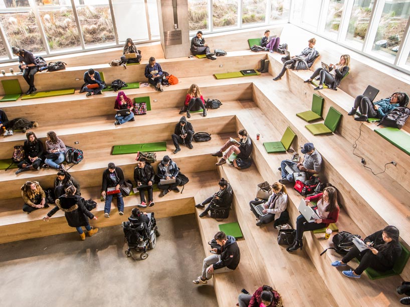 Students sitting and studying on steps in the Student Learning Centre