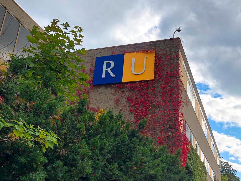 Ryerson logo on building with trees in front of it