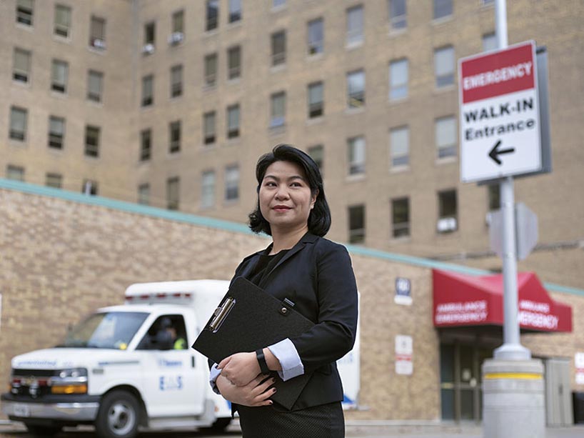 Kittie Pang stands in front of the emergency entrance of a hospital