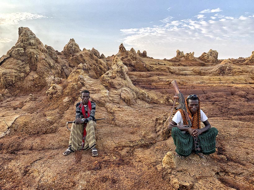Two militiamen sit with weapons in the Danakil Desert
