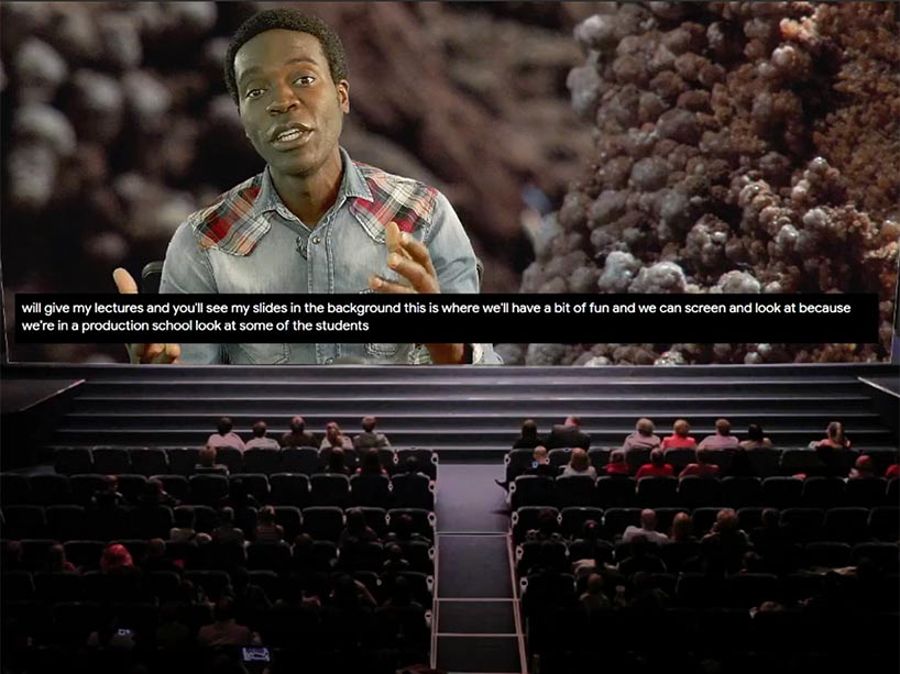 Kristopher Alexander appears on a large screen in front of a computer-simulated lecture hall.