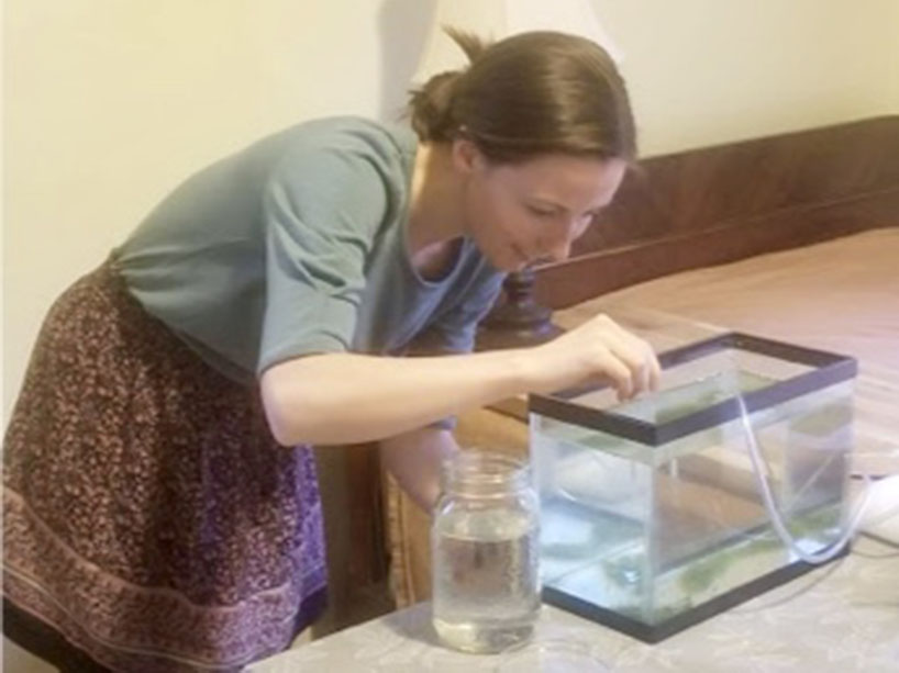 Rachel McNamee oxidizing a water tank in her home lab setup