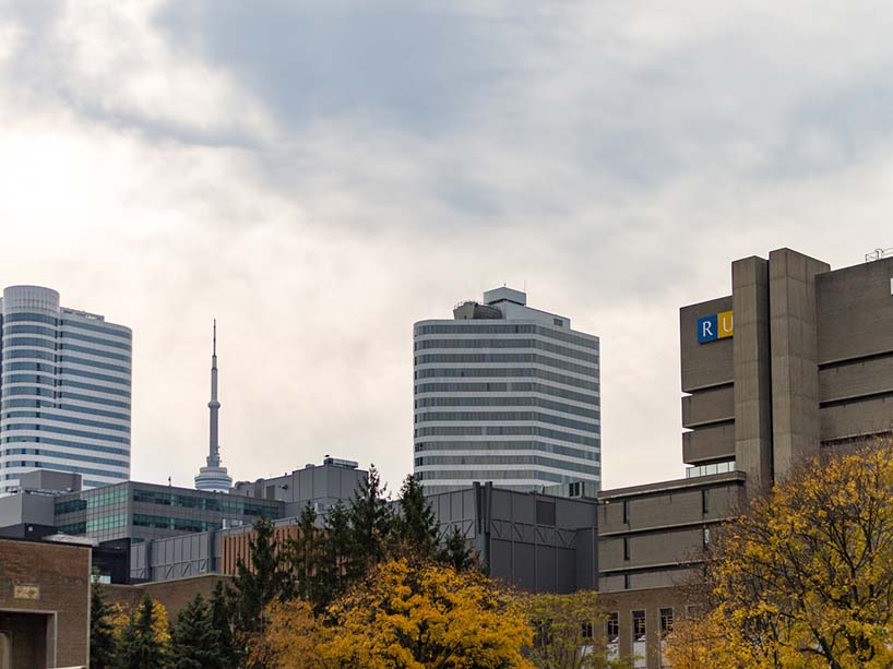 Photo of the Toronto skyline including Ryerson Library, the CN Tower and other buildings.