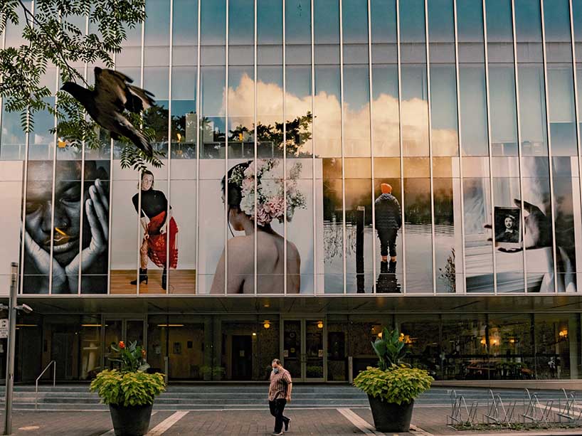Photo of Ryerson Image Centre with a person walking in front of the building.