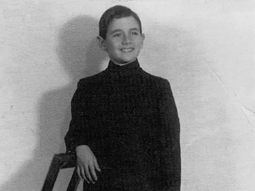 A teenage boy wearing a school uniform.