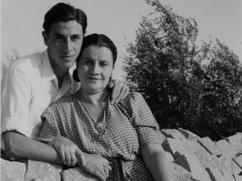 A young man with his arm around his mother.