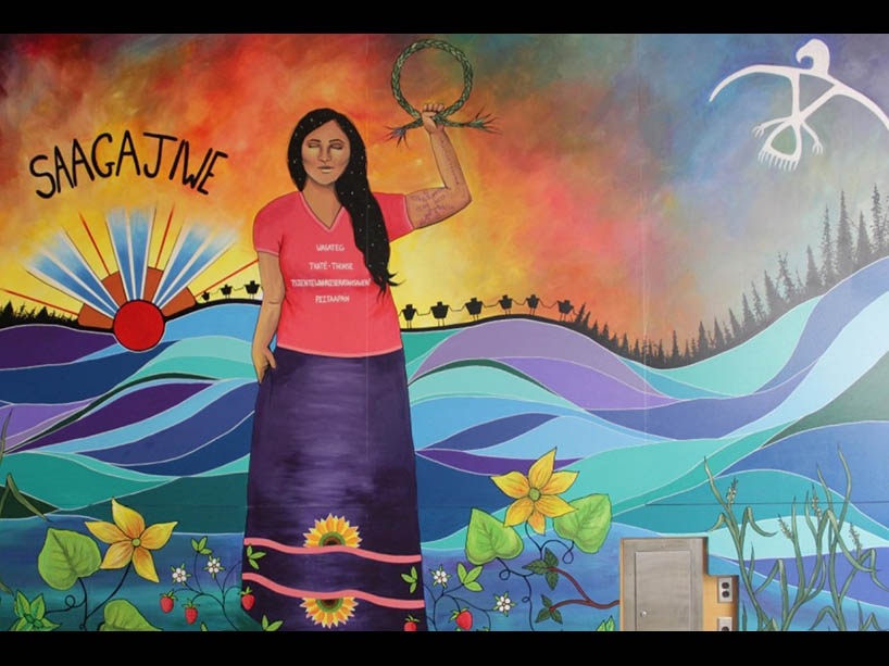 A mural of a woman standing amid water.