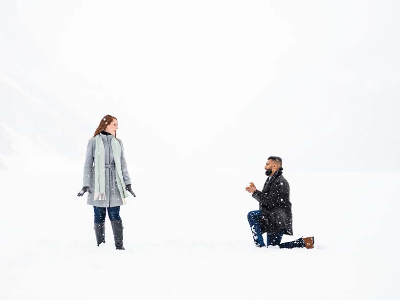 Bailey Parnell and Hamza Khan standing outside in a snowy landscape.