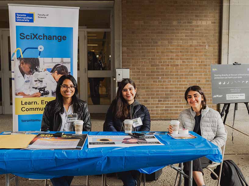 Members of SciXchange, TMU’s outreach office for the Faculty of Science, sit at a booth ready to chat all things science with attendees.