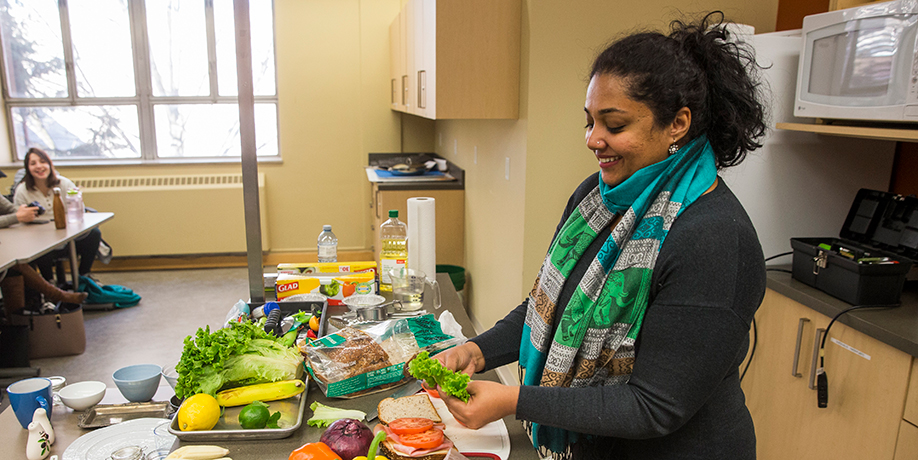 Nutrition instructor preparing foods at kitchen counter