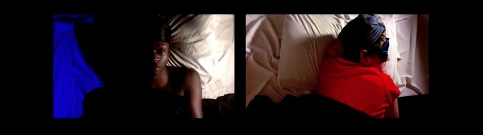 From above, a split screen of two actors lying in bed. The actor on the left lies awake at night, while the other appears to be asleep with an eye mask on.