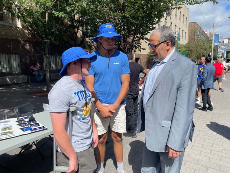President Lachemi talks with two students on Gould street.