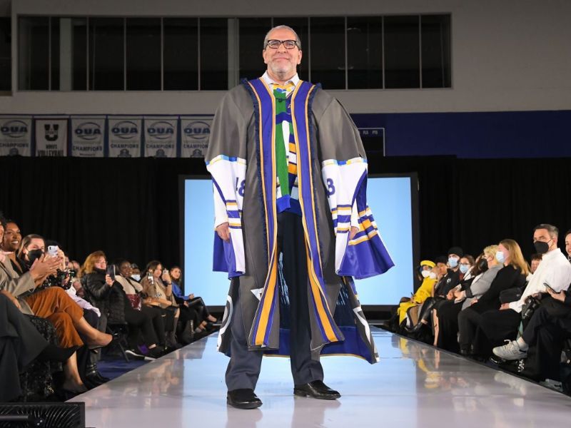 President Lachemi models an upcycled gown and sweater