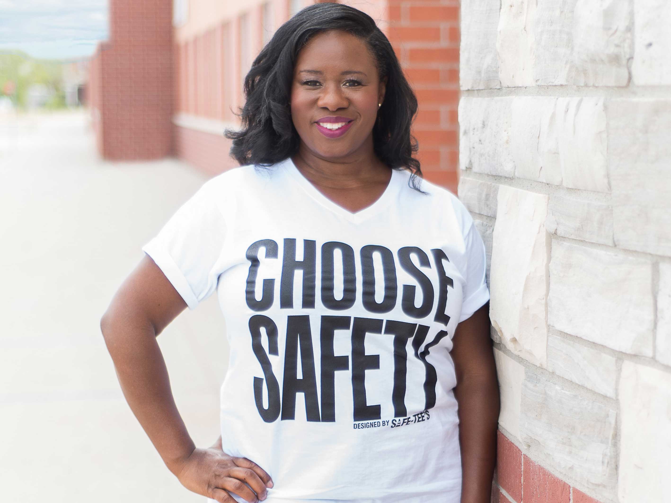 Lee-Anne Lyon-Bartley wearing a choose safety shirt standing against a brick wall.