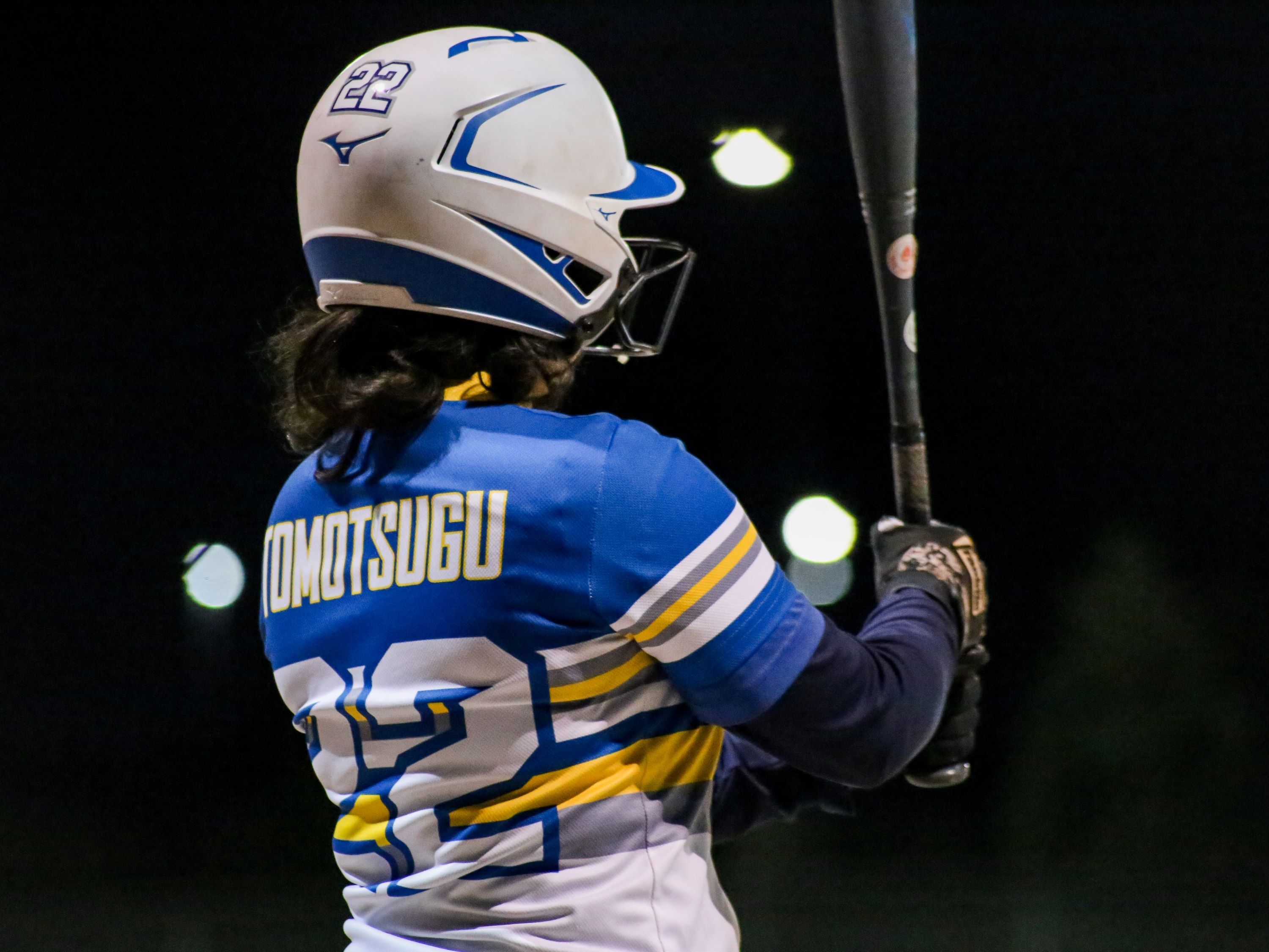 Player in Rams uniform hits the ball with the bat.