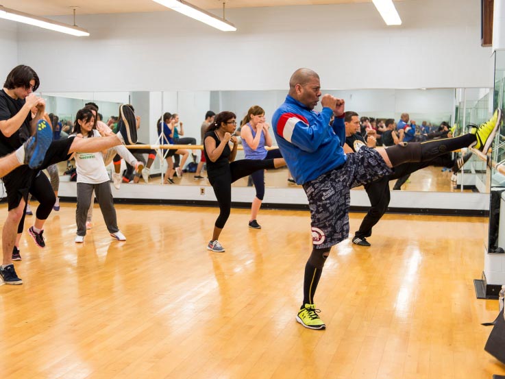 A group of participants in an instructional kickboxing class.