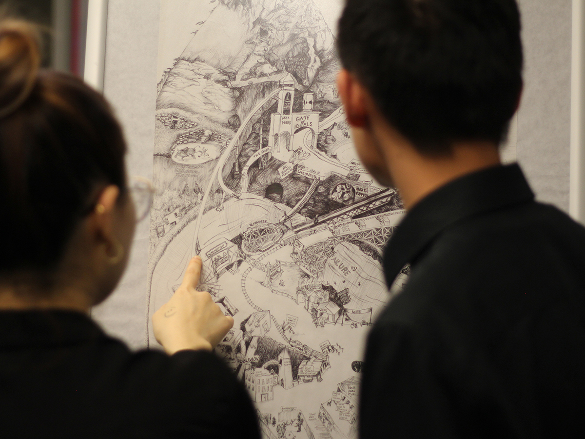 Two individuals looking at a drawing in a gallery