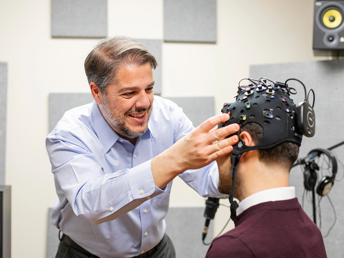 Professor Frank Russo demonstrates a new headset fitted with functional near-infrared spectroscopy (fNIRS) technology and electroencephalography (EEG) technology