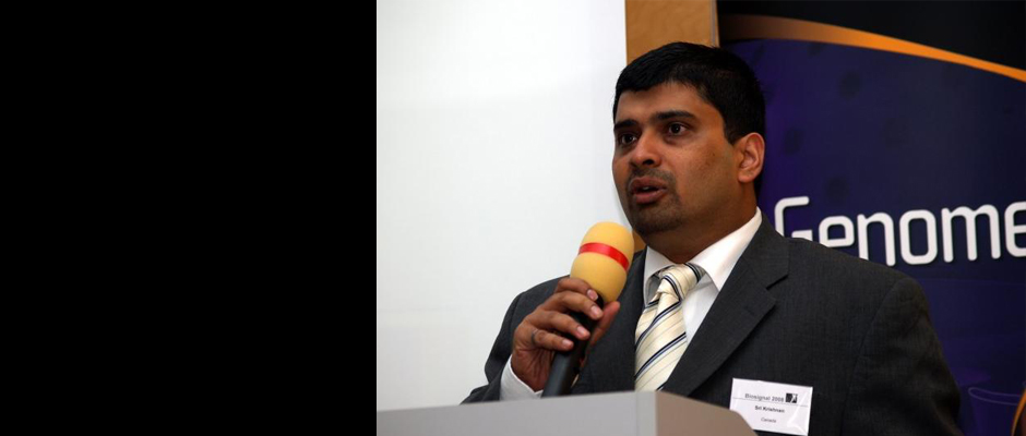 A main slideshow photo of Dr. Krishnan speaking at an event