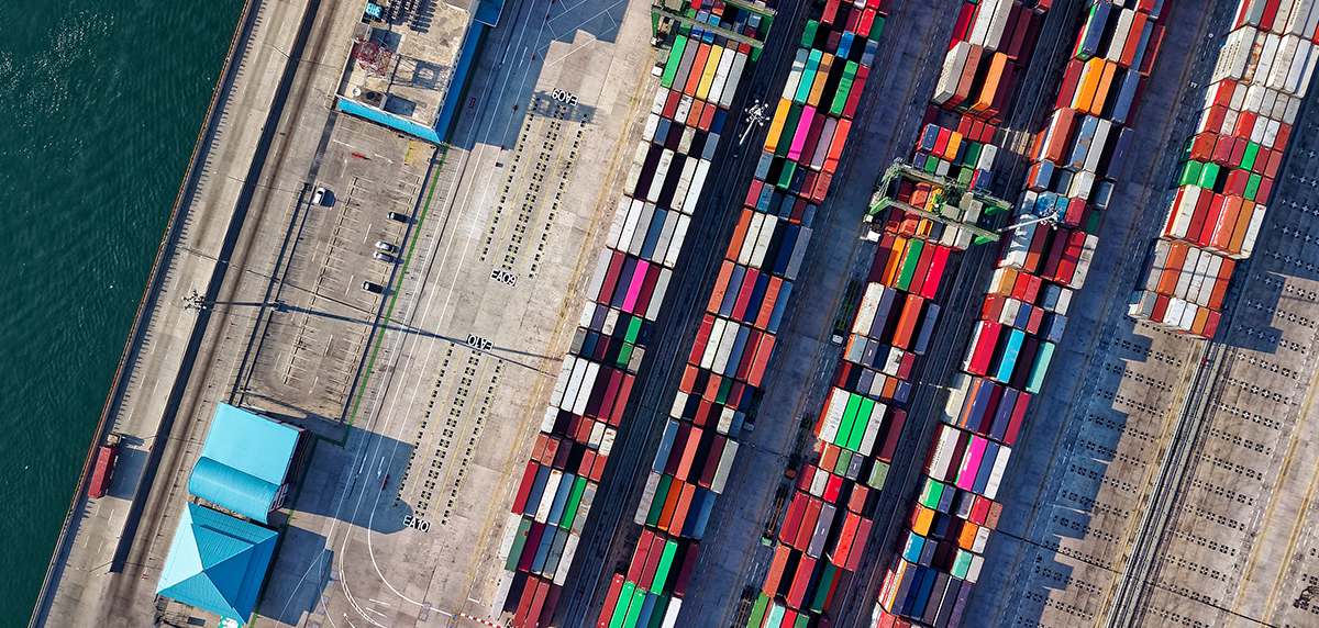 An aerial image of a cement dock with multicoloured shipping containers.