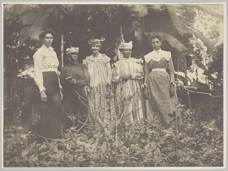 A sepia tinted photo of a group of five Caribbean women.