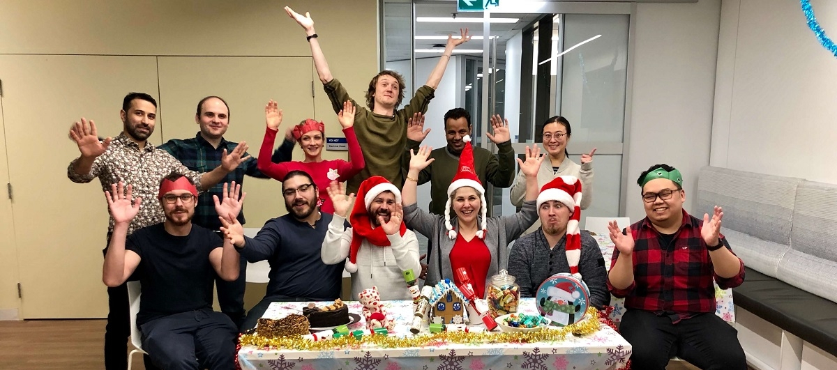 CRL members excitedly posing around a festive table.