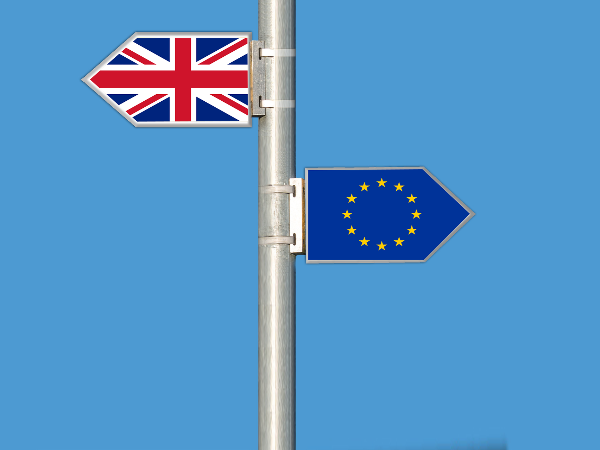 A pole with a Britain flag pointing the other way from the European Union flag