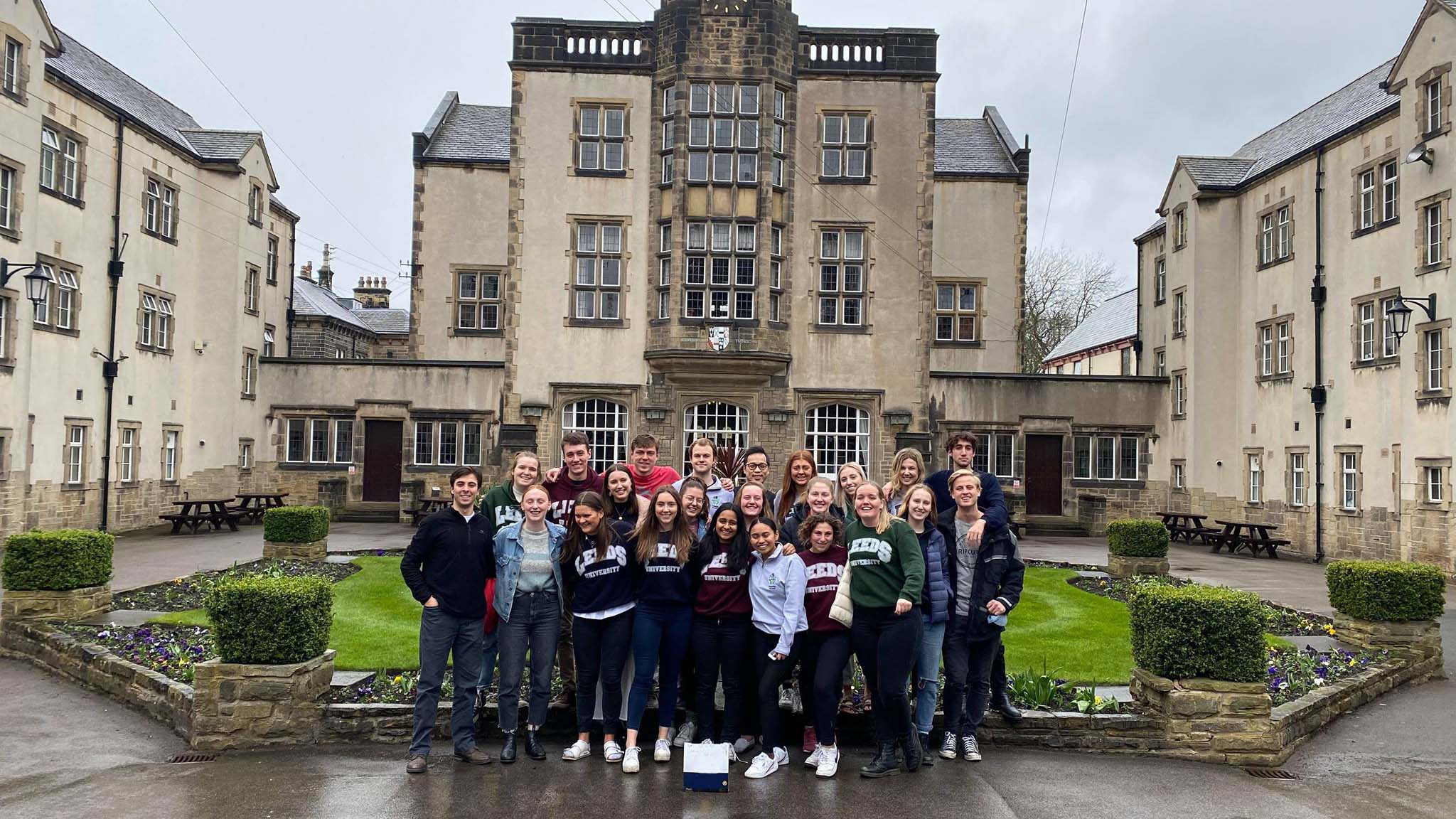 Large group of students gathered in front of European style building in Devonshire
