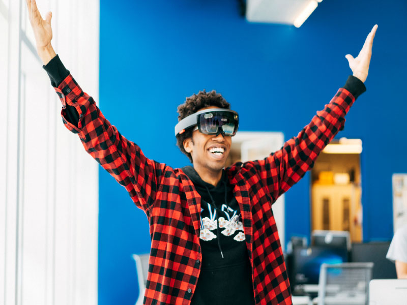 A man in a checkered flannel wearing VR glasses